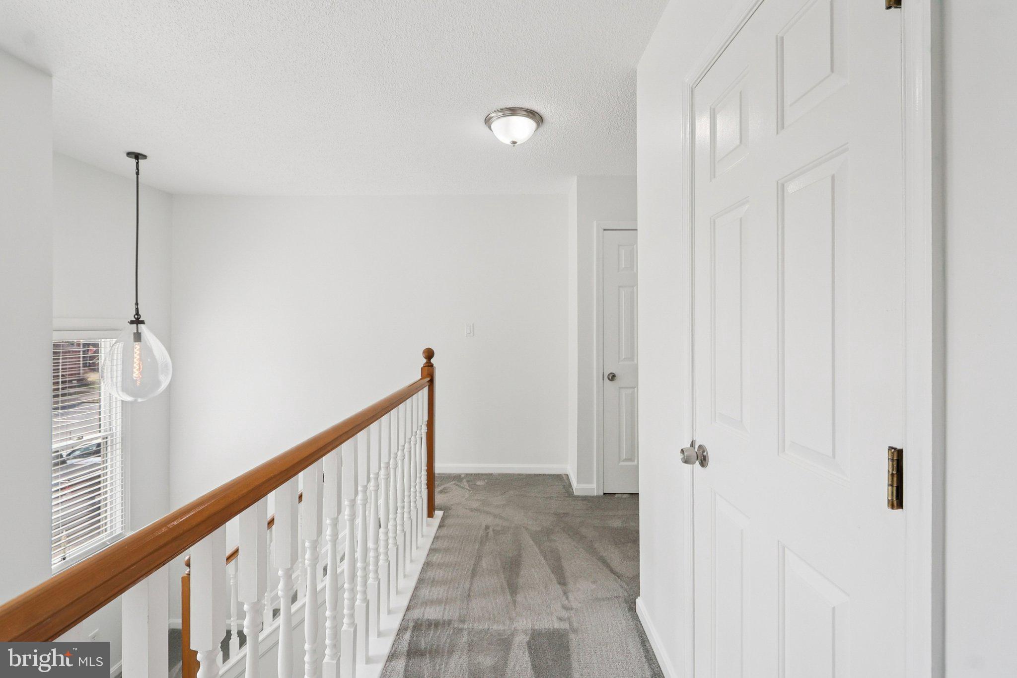 770 Bellefield Road, Unit 107 Solomons, MD 20629 - Photo 23 of 66 Upper Hallway -- open & bright w/ 2 linen closets