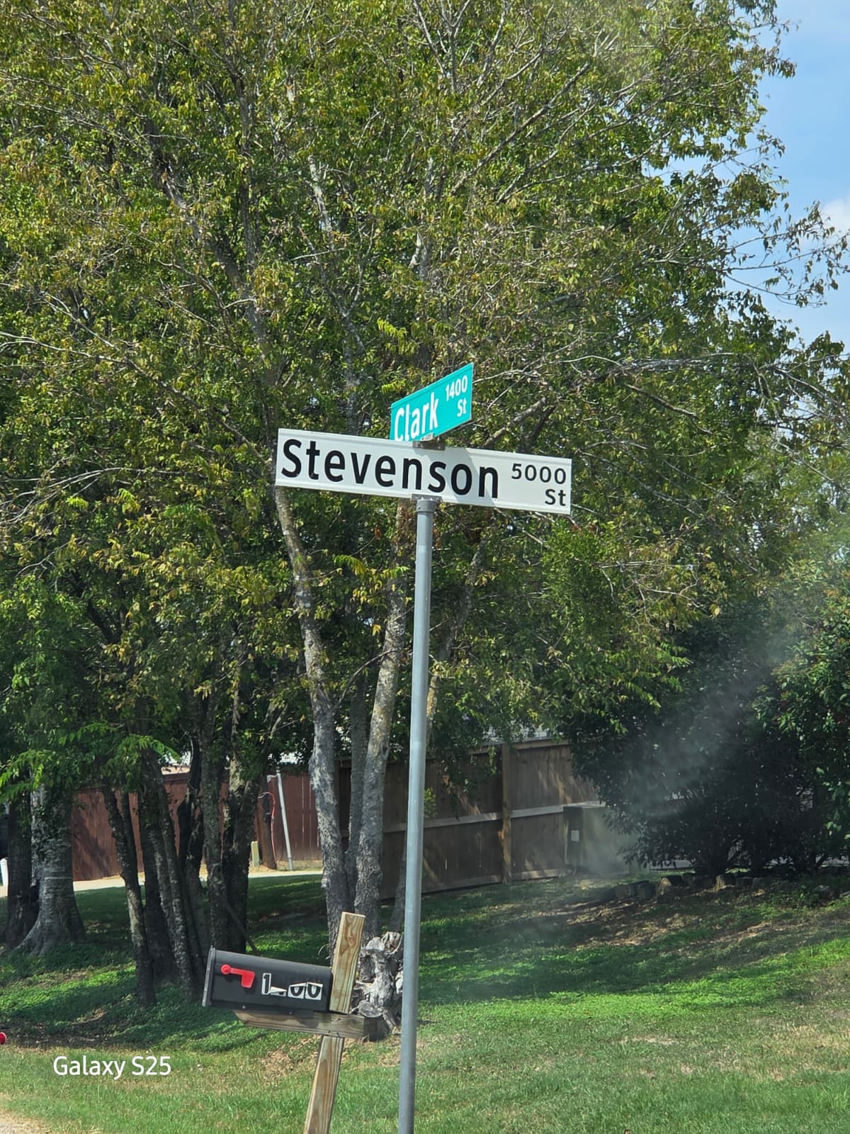 5000 East State Highway 21 Bryan, TX 77808 - Photo 3 of 12 a view of a street sign under a large tree