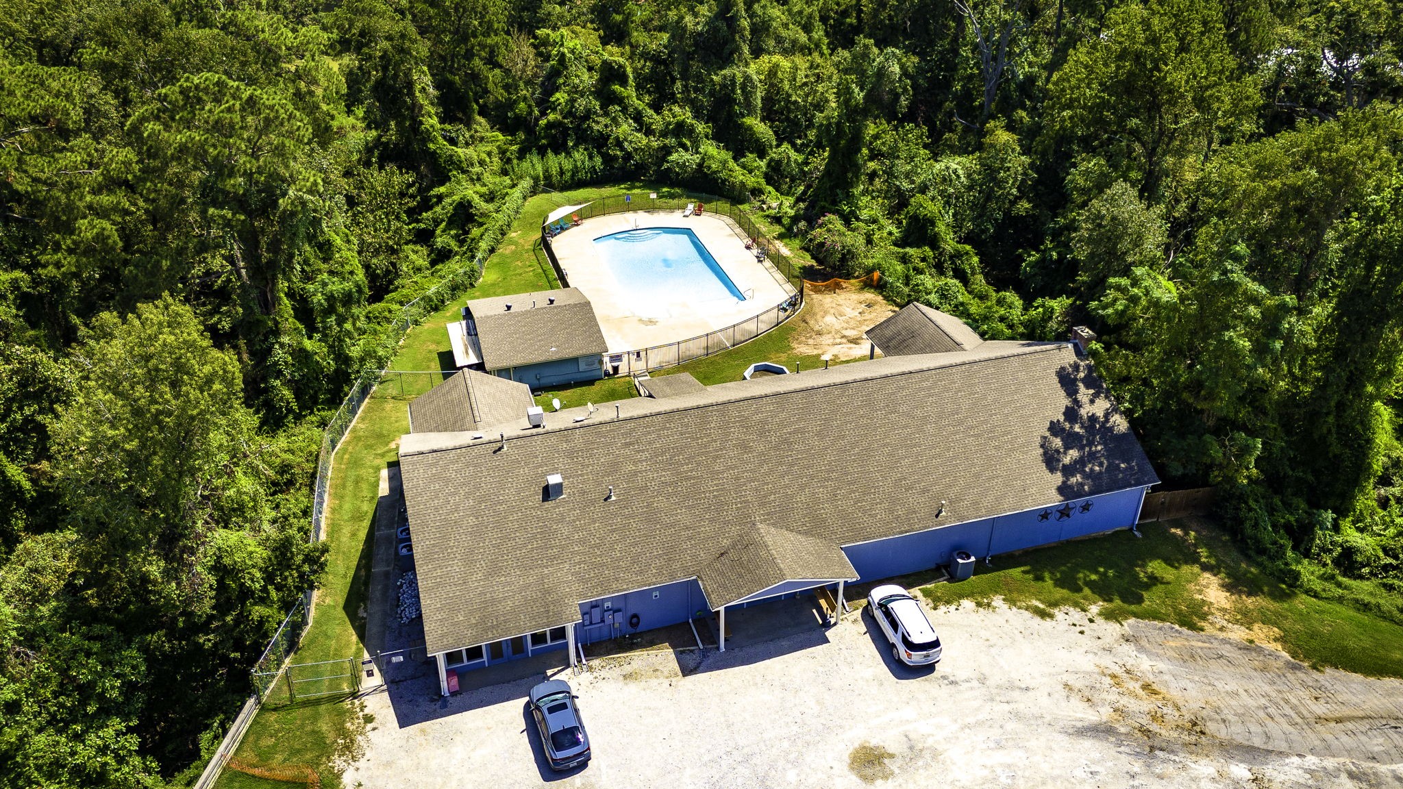 151 Key Largo Loop Point Blank, TX 77364 - Photo 46 of 49 Residents enjoy access to a community clubhouse and sparkling swimming pool surrounded by a peaceful, wooden setting.