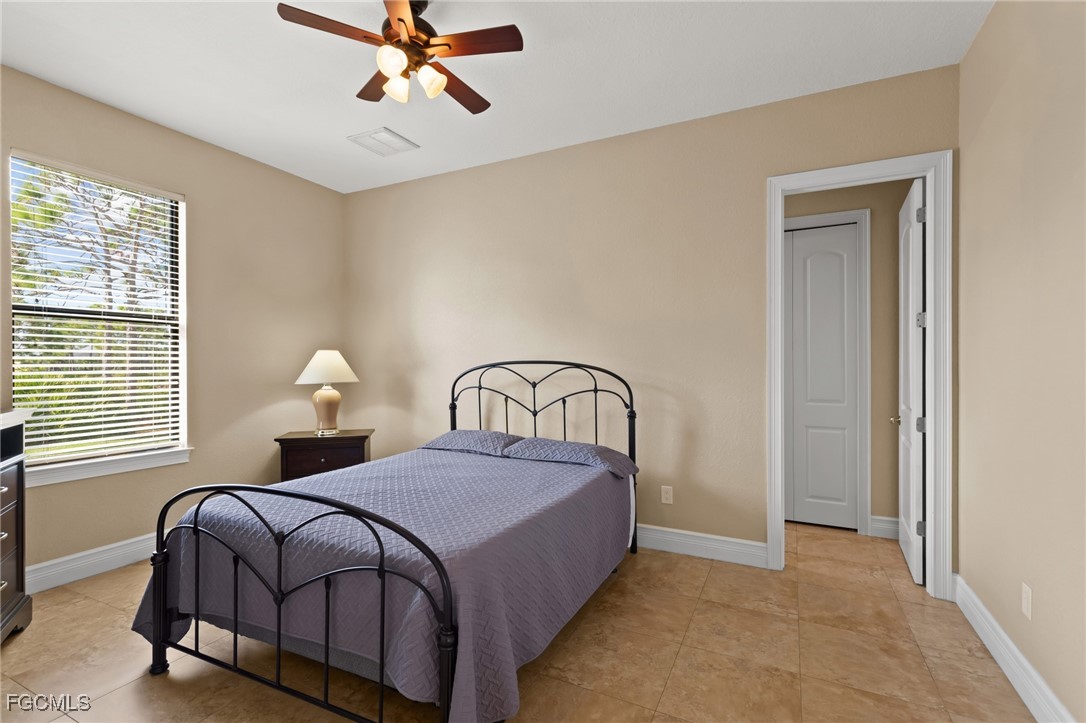 6057 Calusa Rdg Trail Bokeelia, FL 33922 - Photo 23 of 45 a bedroom with a bed and window