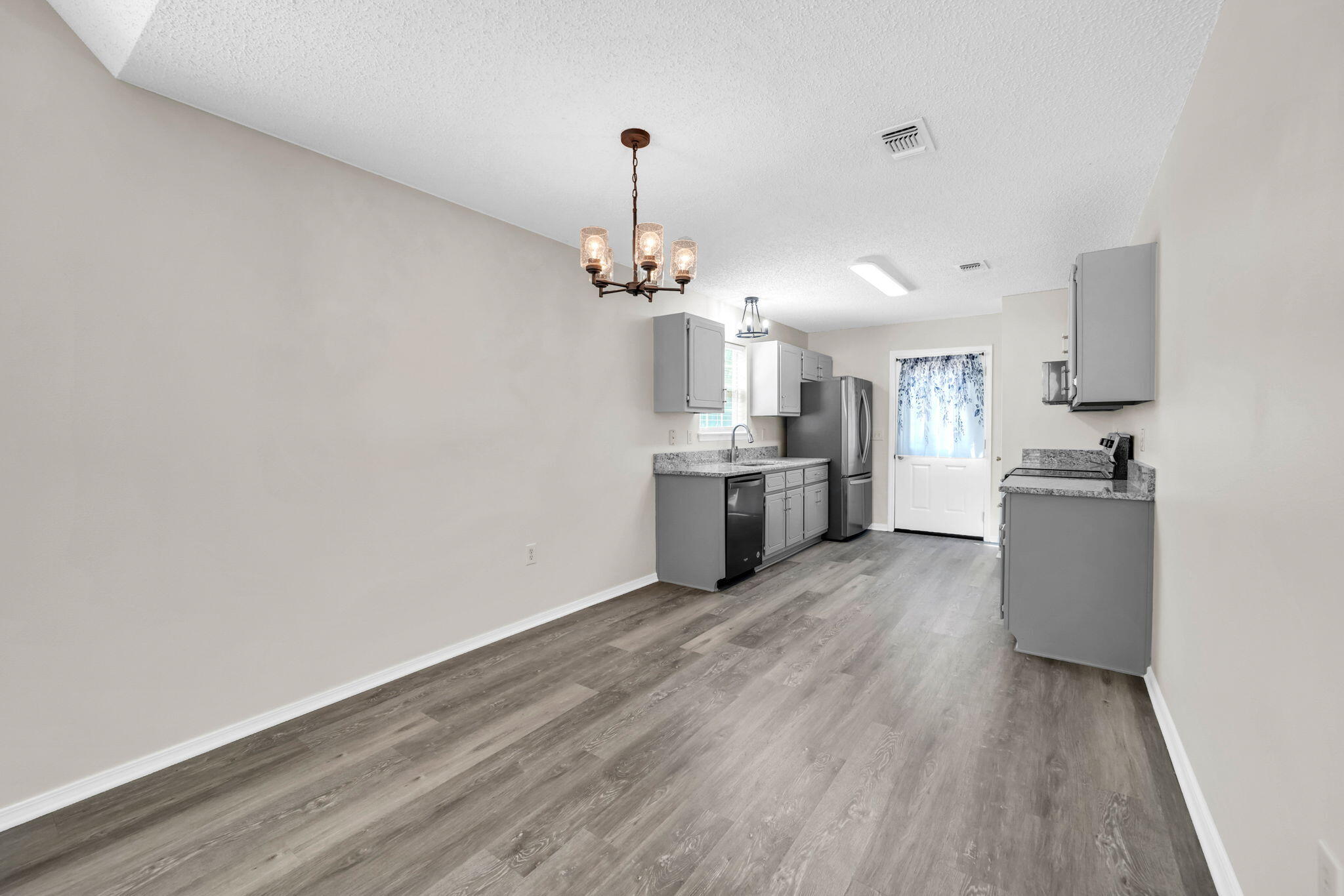 1036 Blue Ridge Drive Fort Walton Beach, FL 32547 - Photo 14 of 31 a view of a kitchen with a sink a refrigerator and wooden floor