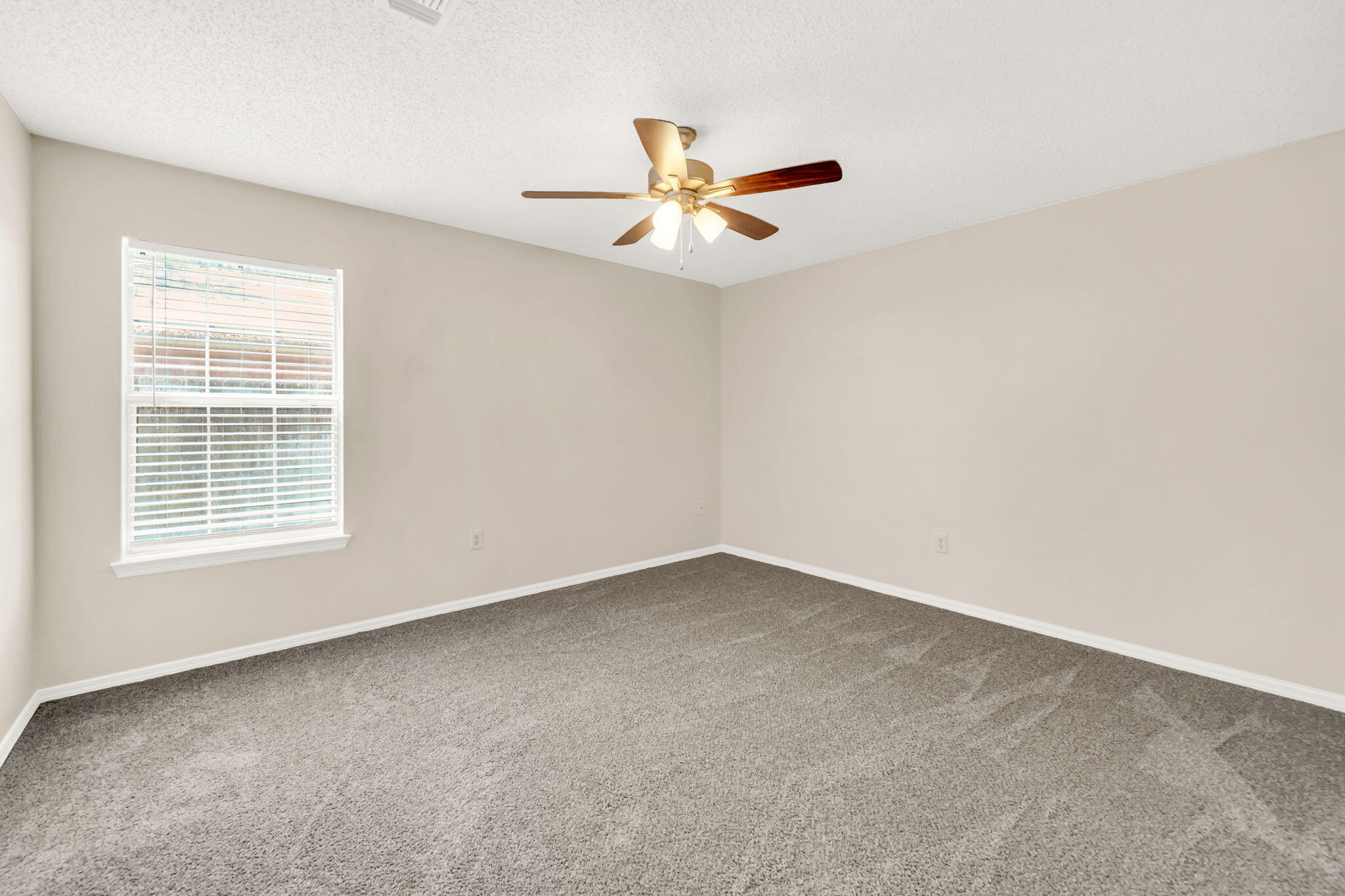 1036 Blue Ridge Drive Fort Walton Beach, FL 32547 - Photo 17 of 31 an empty room with a window and a ceiling fan