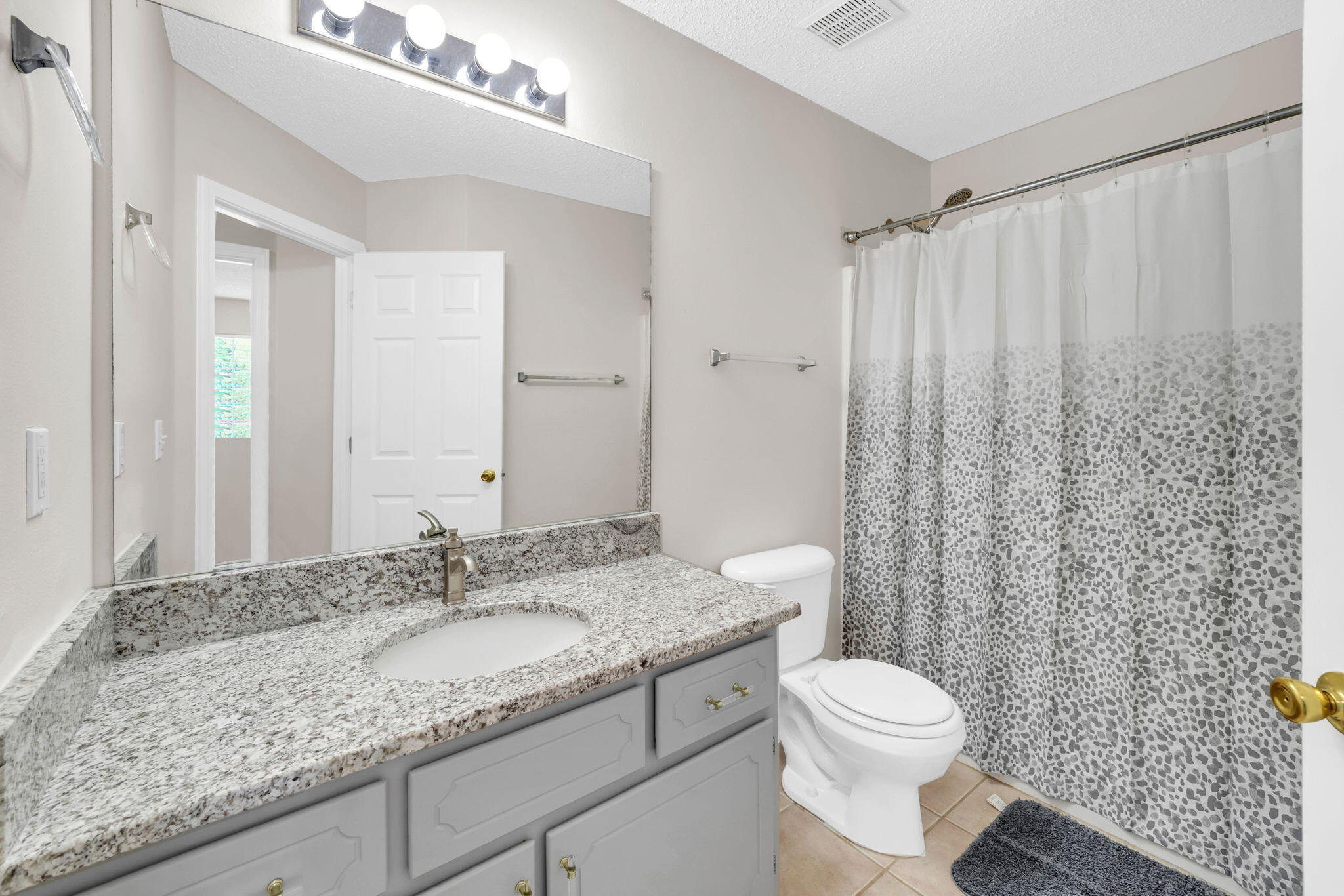 1036 Blue Ridge Drive Fort Walton Beach, FL 32547 - Photo 27 of 31 a bathroom with a granite countertop sink and a mirror