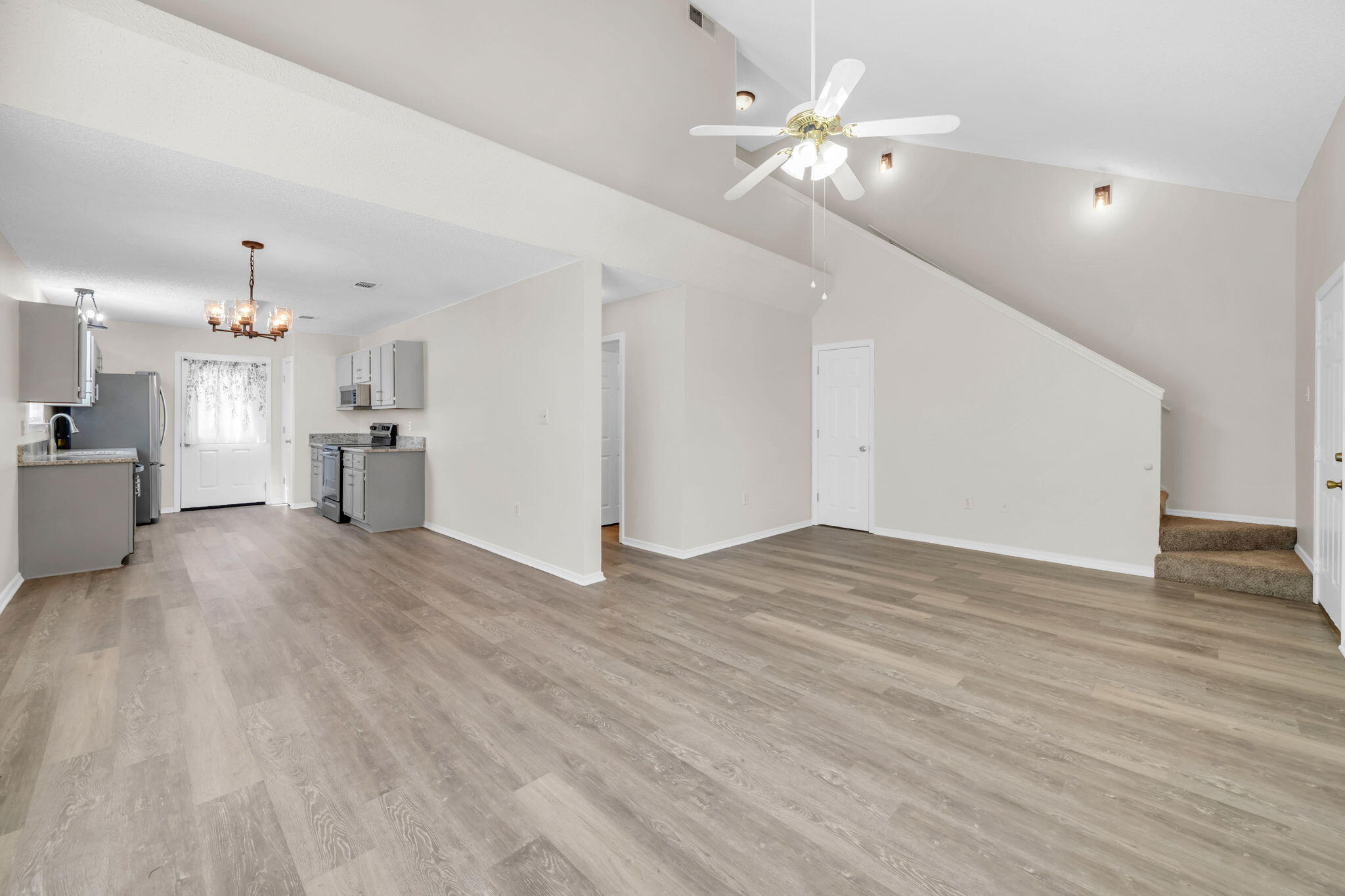 1036 Blue Ridge Drive Fort Walton Beach, FL 32547 - Photo 5 of 31 a view of an empty room with wooden floor and a ceiling fan