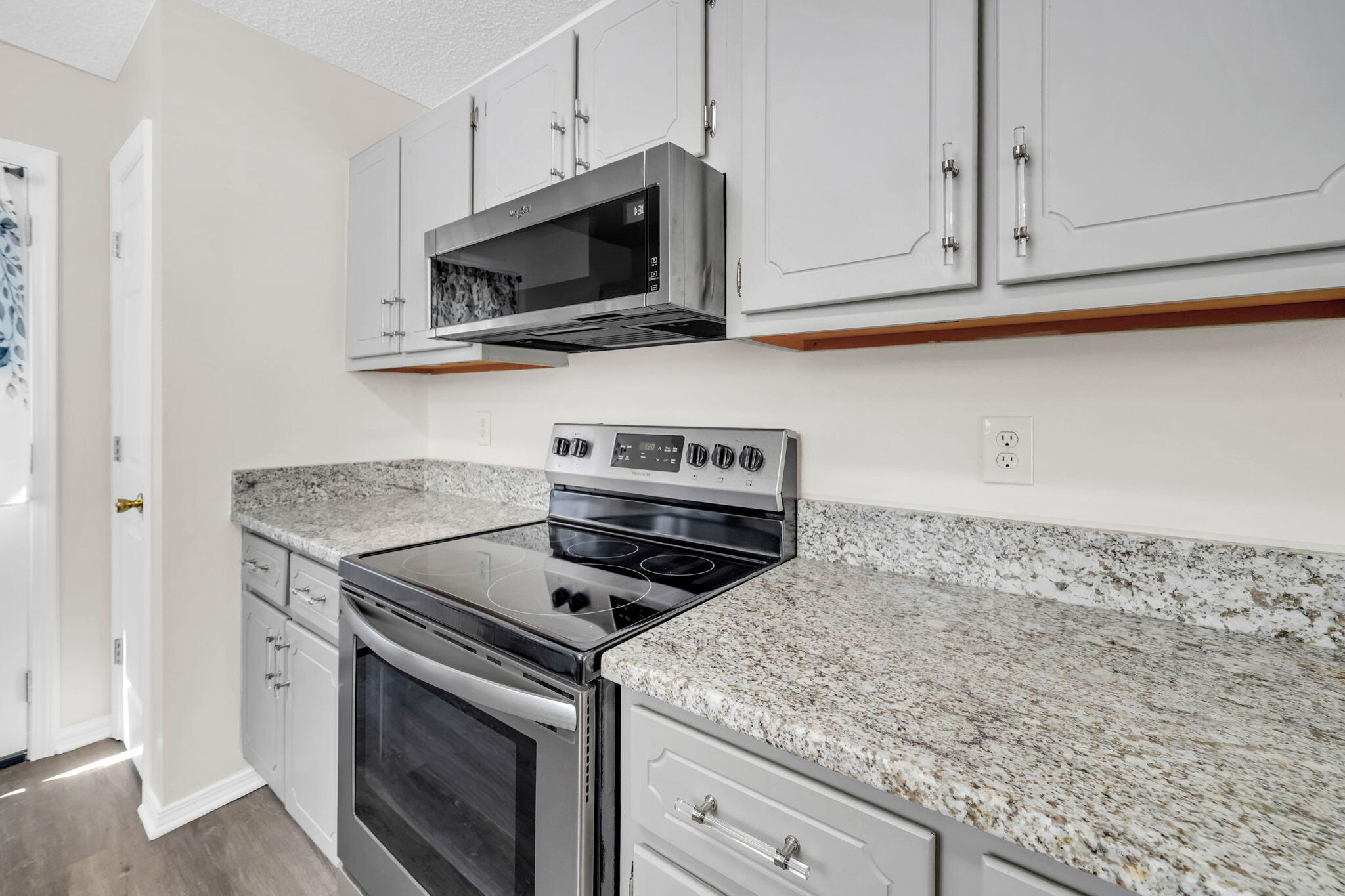 1036 Blue Ridge Drive Fort Walton Beach, FL 32547 - Photo 10 of 31 a kitchen with granite countertop white cabinets stainless steel appliances and a sink