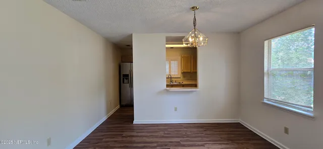 a view of a room with wooden floor and windows