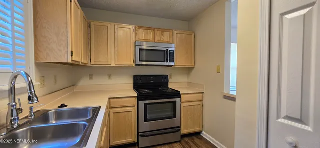 a kitchen with a stove and a microwave