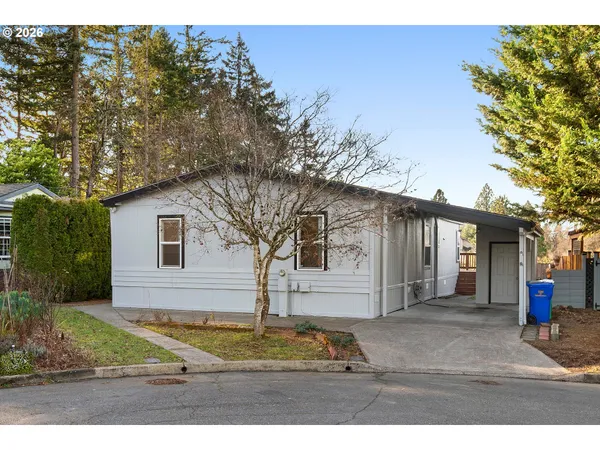 a house that has a tree in front of it