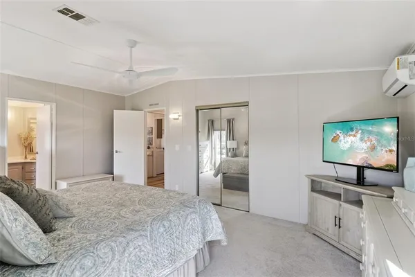 a bedroom with a bed and a flat screen tv