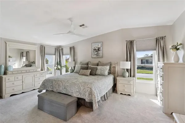 a spacious bedroom with a bed and a cabinets