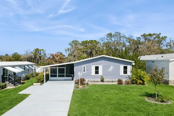 a view of an house with backyard space and garden