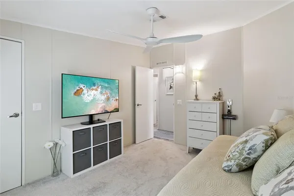 a bedroom with furniture and a flat screen tv