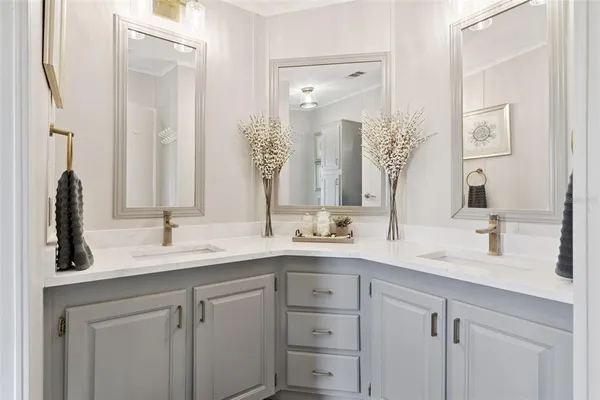 a bathroom with a double vanity sink mirror and