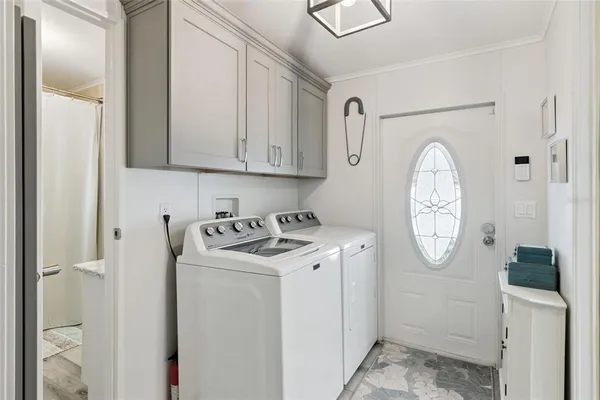 a view of a storage and utility room with utility room washer and dryer