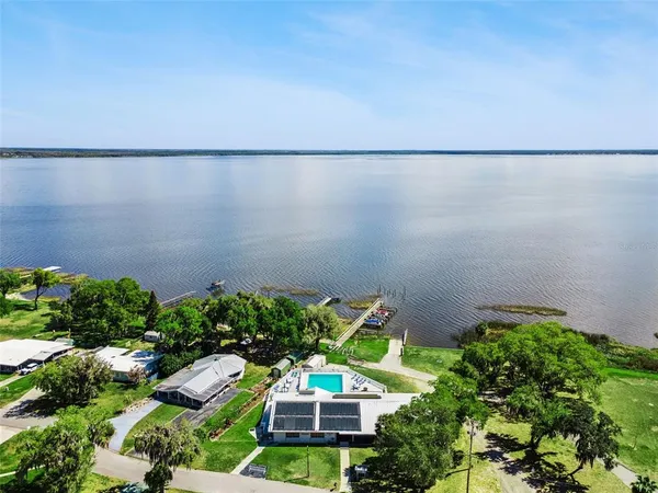 an aerial view of a house with a yard