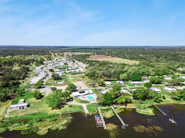 an aerial view of a houses with a yard