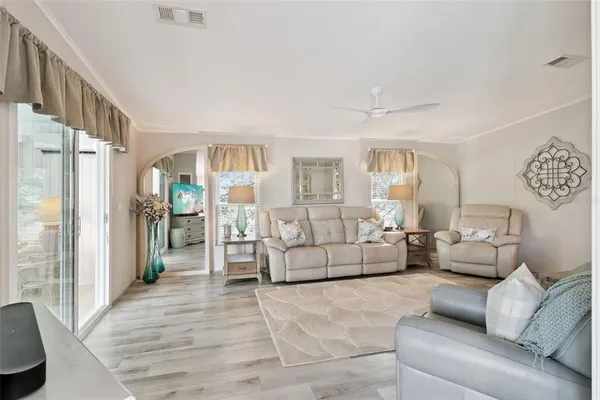 a living room with furniture and a glass door shower