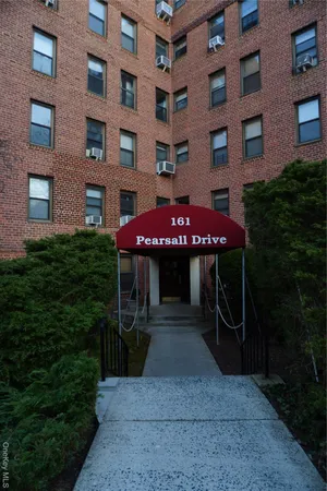 a front view of a building with a garden