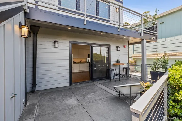 a view of a patio with a table and chairs