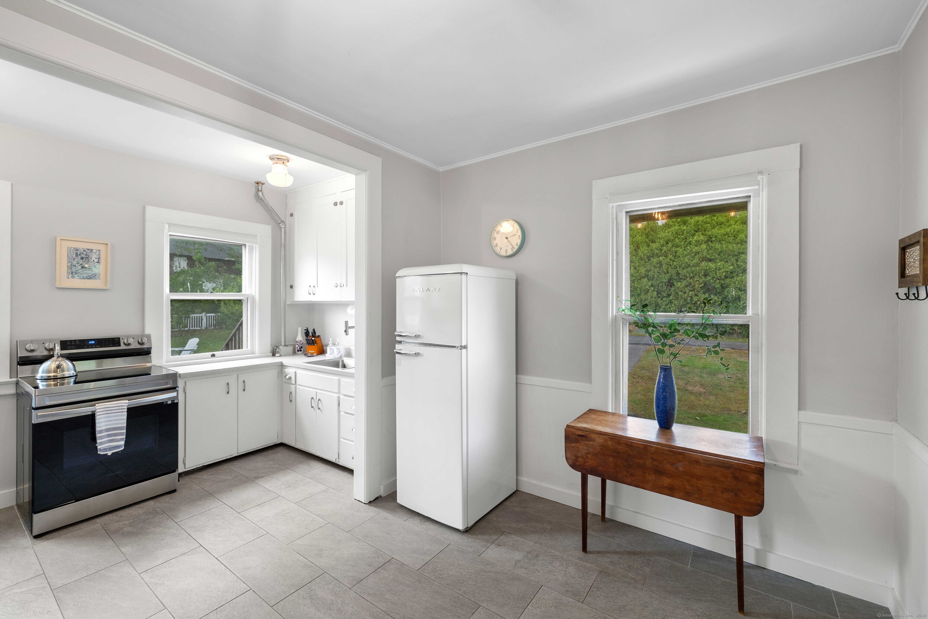 16 Prospect Hill Road Groton, CT 06340 - Photo 12 of 38 a kitchen with a refrigerator and white cabinets