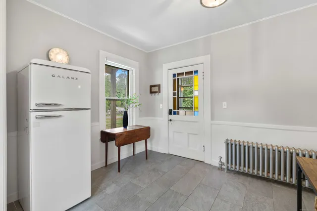 a kitchen with cabinets appliances a sink and a window