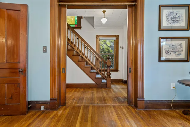 a view of entryway with wooden floor and a front door