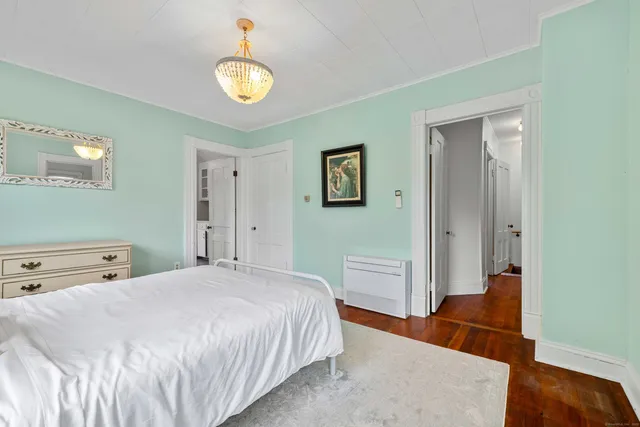 a bedroom with a bed lamp and a window