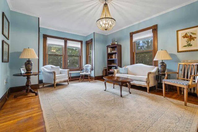 a living room with furniture and a bookshelf