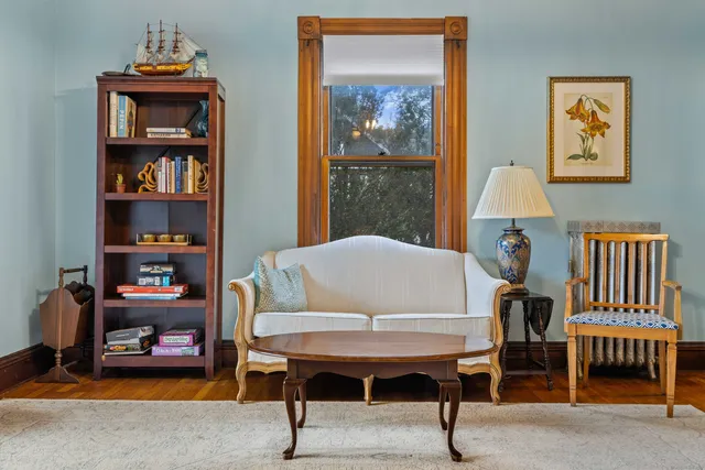 a living room with furniture and a chandelier