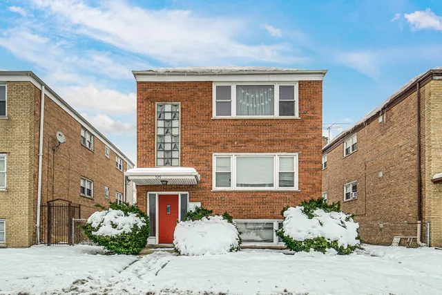 a front view of a house with potted plants
