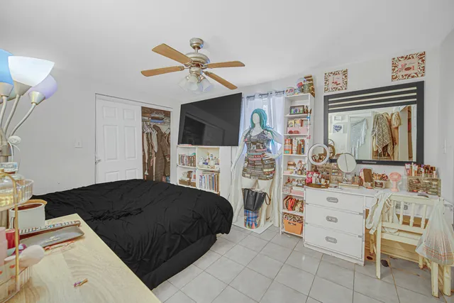 a bedroom with furniture and a flat screen tv