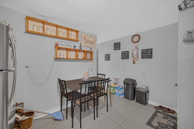 a view of a dining room with furniture and a chandelier