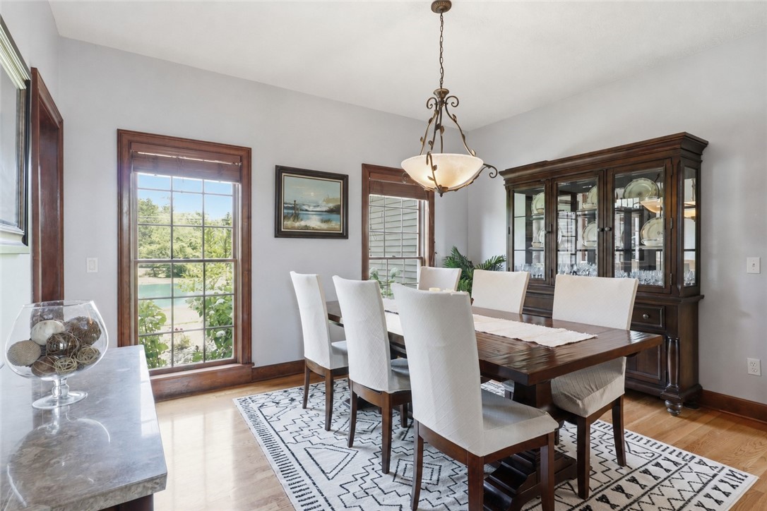 2057 Stirnie Road Victor, NY 14564 - Photo 15 of 48 The separate formal dining room features large twin windows that provide scenic views across the expansive 5.10-acre front lawn and pond, complete with plush carpeting and a sophisticated layout.