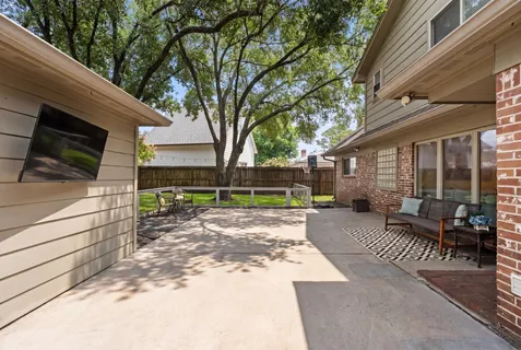 a view of a house with backyard and sitting area
