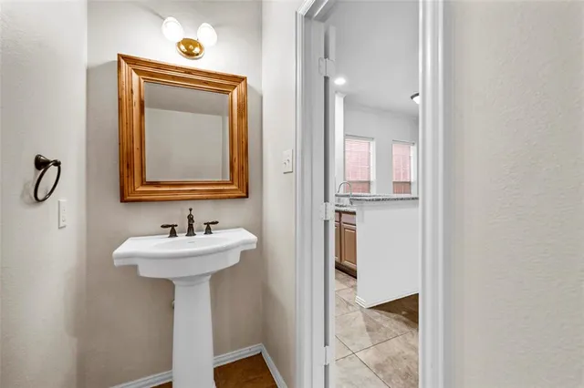 a bathroom with a sink mirror and toilet