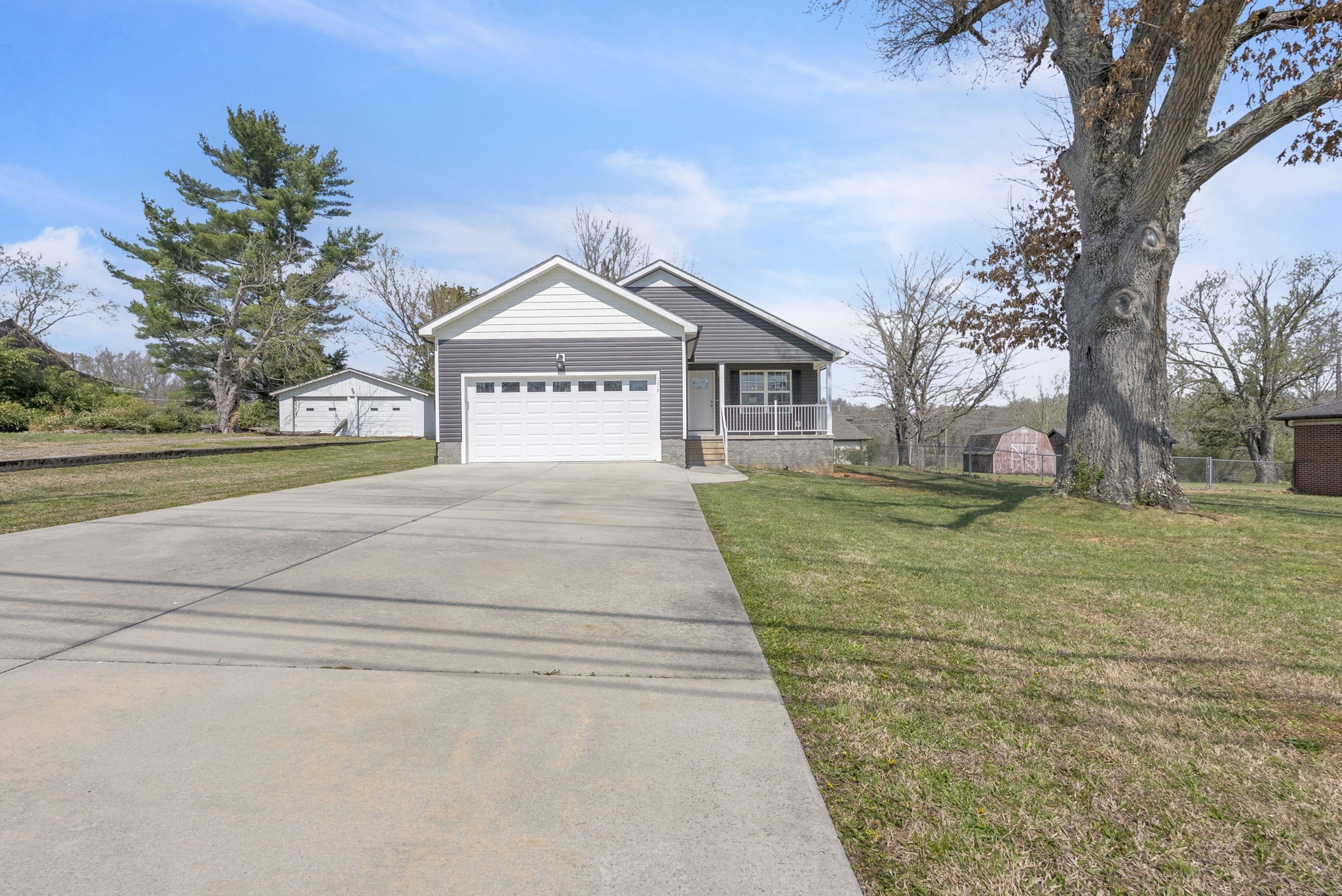 156 Old Post Road McMinnville, TN 37110 - Photo 3 of 33 a front view of a house with a yard and garage