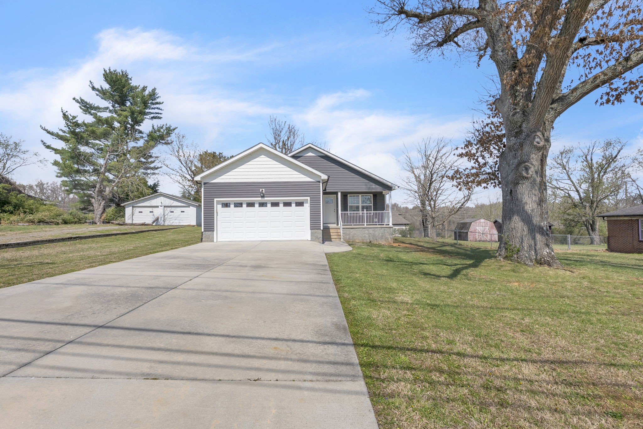 156 Old Post Road McMinnville, TN 37110 - Photo 4 of 33 a front view of a house with a yard and garage
