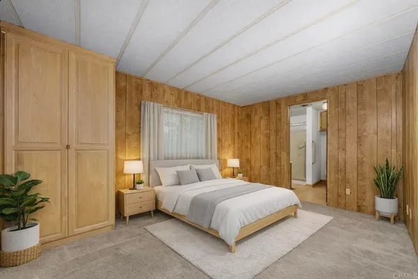 a bedroom with a bed and a potted plant