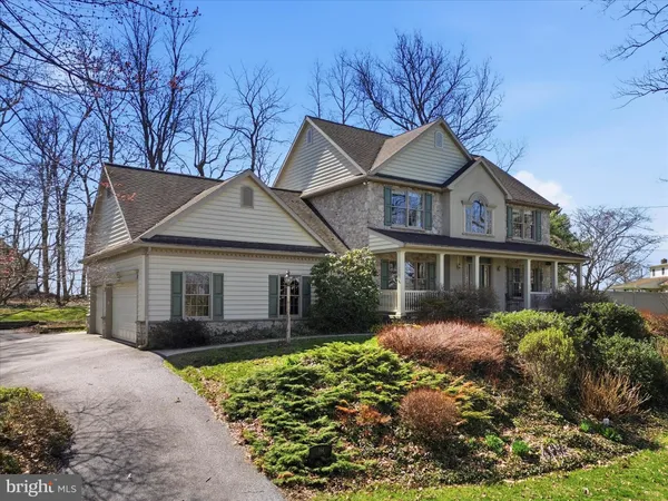 a front view of a house with a yard and potted plants