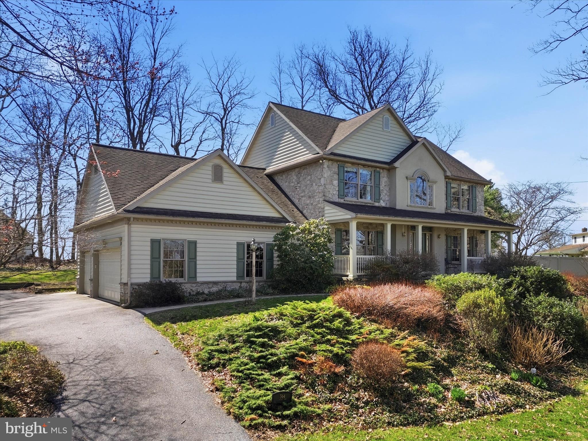 a front view of a house with a yard and potted plants