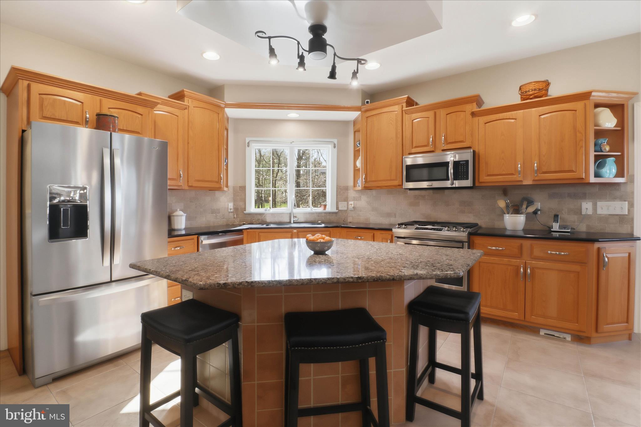 364 Evans Road Lititz, PA 17543 - Photo 19 of 58 a kitchen with stainless steel appliances granite countertop a stove a sink a microwave a refrigerator and white cabinets