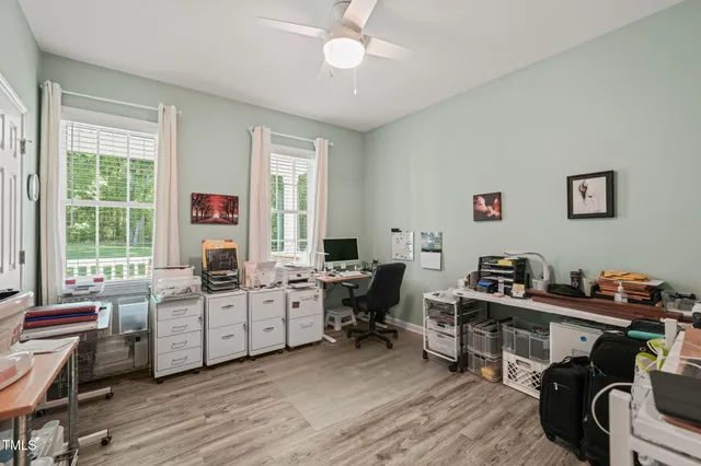a view of a workspace with furniture and a window