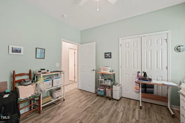 a view of a workspace with furniture and wooden floor