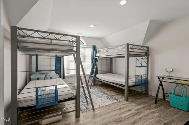 a bedroom with furniture and wooden floor