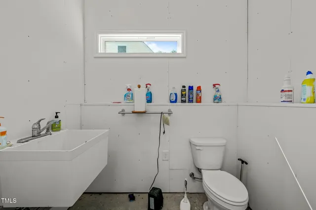 a white toilet sitting next to a bathroom sink