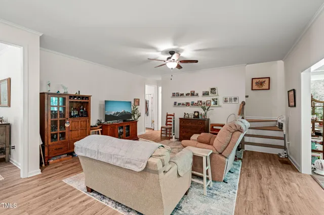 a living room with furniture fireplace and wooden floor