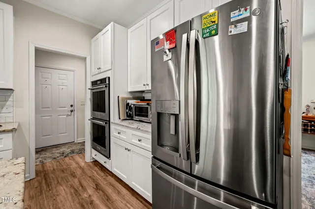 a kitchen with stainless steel appliances a refrigerator sink and microwave