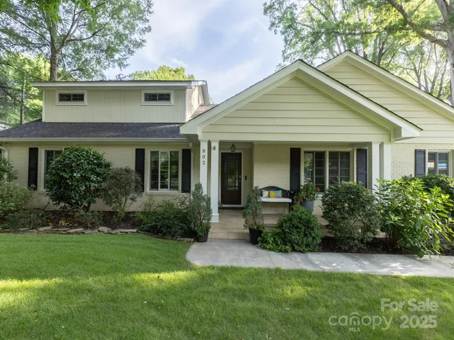 a front view of a house with a yard and porch