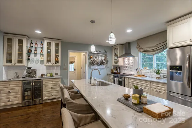 a kitchen with a stove a refrigerator and wooden cabinets