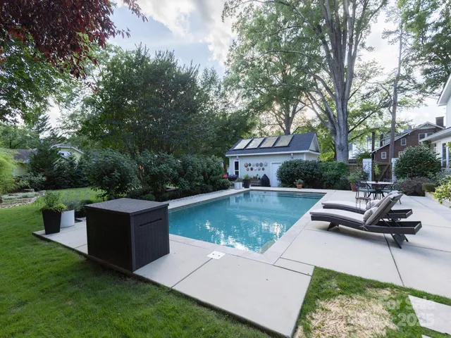 a view of a house with pool and sitting area